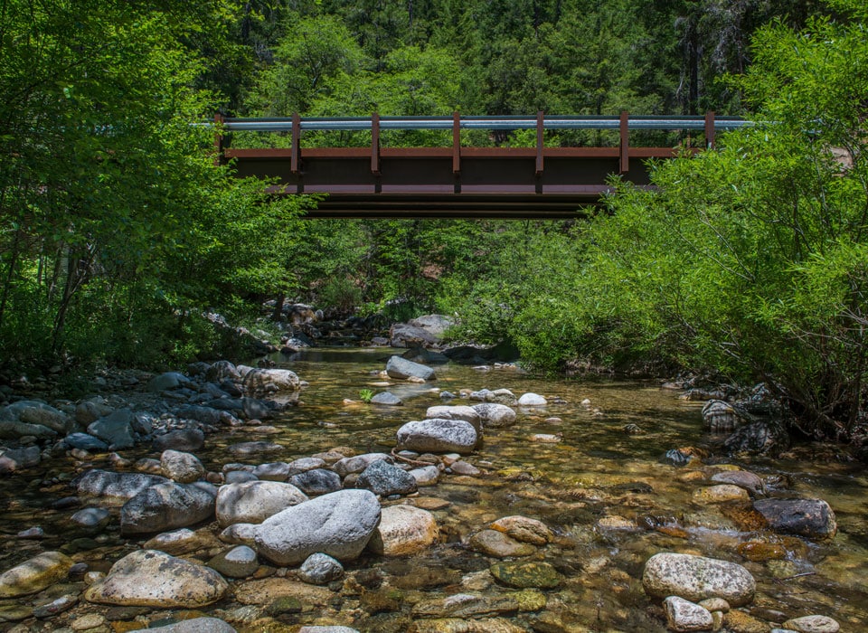 a river embankment and a bridge that crosses over