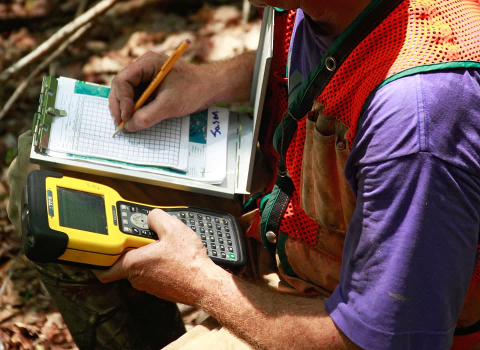 a close up view of a forester using various tools