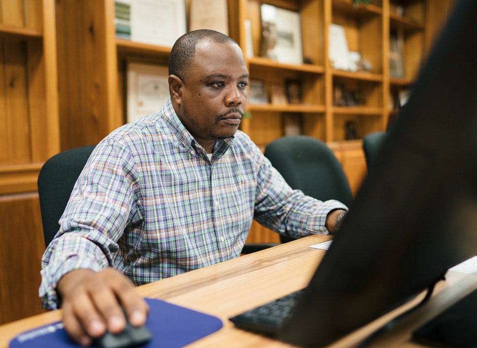 an F&W Forestry employee uses a computer to analyze data